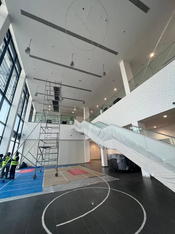 BMW showroom atrium mid fit-out with scaffolding and crew