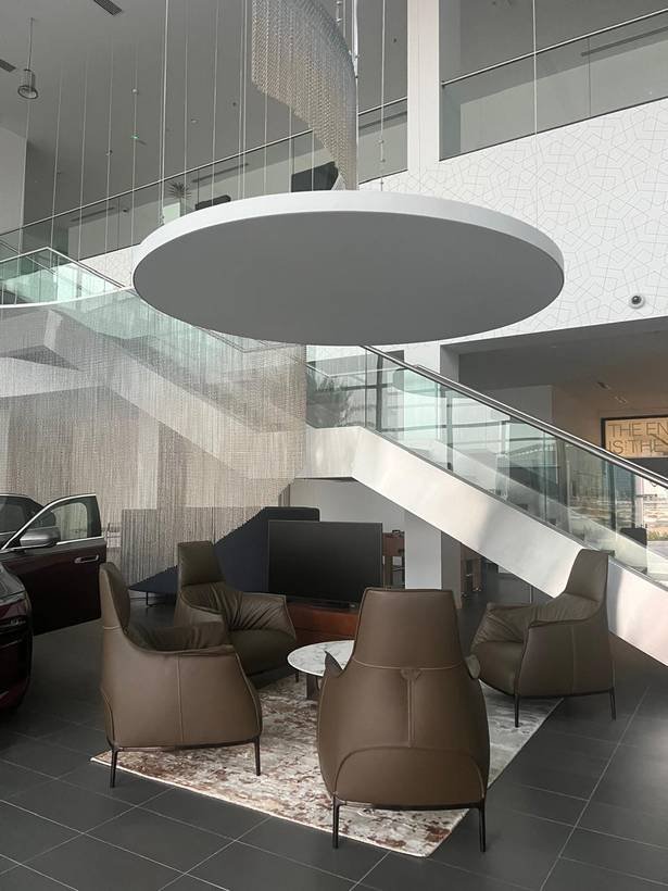Completed BMW showroom atrium with car display and lounge seating