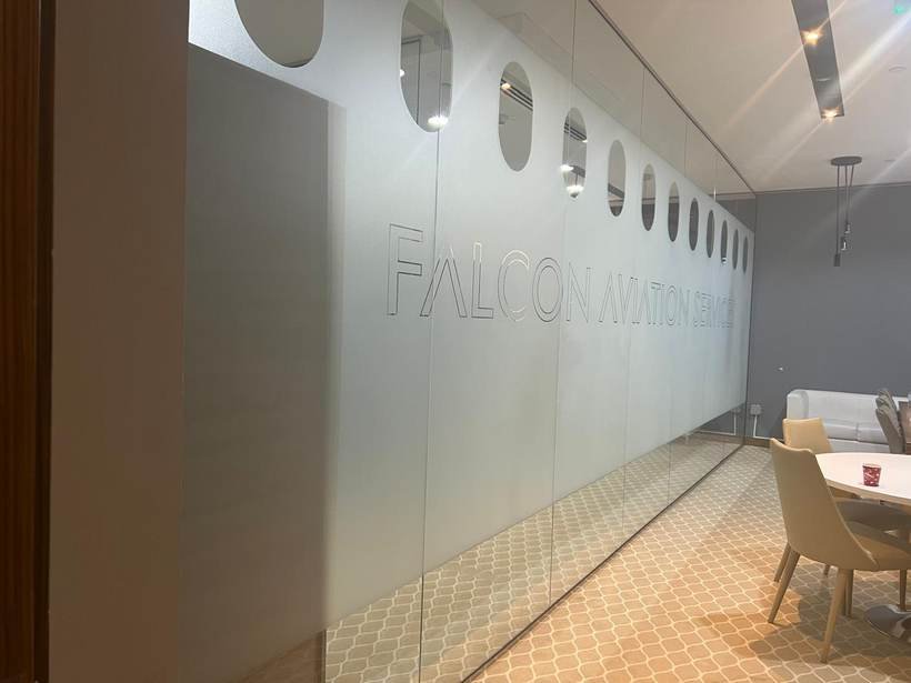 Falcon Aviation Services frosted glass wall with aircraft window motif